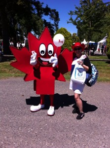 Maple leaf mascot accepting new toothbrush from dental staff